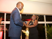 Dr. Nilda Arduin recives Royal Decoration from Governor Eugene Holiday.