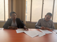 Malera and Drouet putting pen to paper