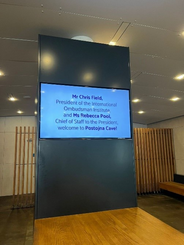 Welcome message to IOI President, Chris Field PSM, and Chief of Staff to the IOI President, Rebecca Poole, displayed at the entrance of Postojna Cave