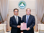 Commissioner Against Corruption Chan Tsz King (left) submits CCAC's 2020 Annual Report to the Chief Executive Ho Iat Seng
