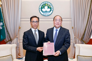 Commissioner Against Corruption Chan Tsz King (left) submits CCAC's 2020 Annual Report to the Chief Executive Ho Iat Seng