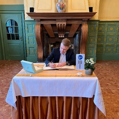 IOI President, Chris Field PSM, signing the “Golden Book” of visiting dignitaries