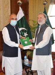 Governor Khyber Pakhtunkhwa Shah Farman is being presented the Annual Report by Ombudsman Syed Jamal Ud Din Shah