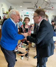IOI President, Chris Field PSM, with a member of the day care centre, Hiša dobre volje, at the Nova Gorica Home for the Elderly.