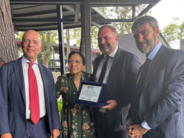 Italian civil defenders present a commemorative plaque to the IOI President