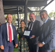 Italian civil defenders present a commemorative plaque to the IOI President