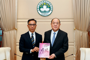 Commissioner Chan Tsz King submitting 2022 Annual Report to Chief Executive Ho Iat Seng